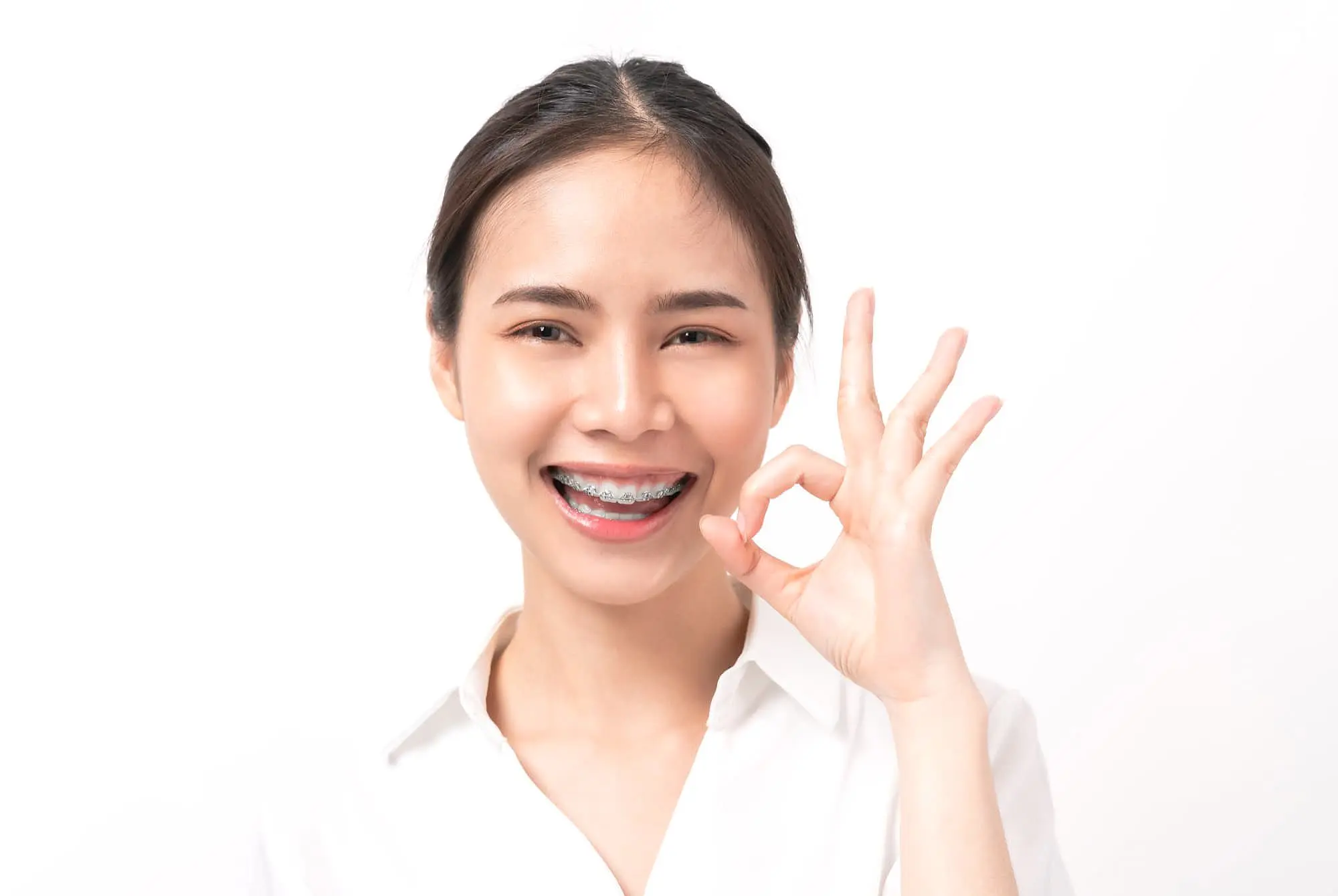 Woman with metal braces smile find the right orthodontic in Prosper or Colleyville, TX